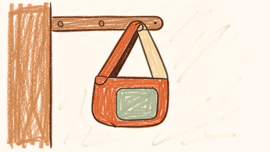 A child's crayon drawing of a baby carrier hanging on a hook by the door